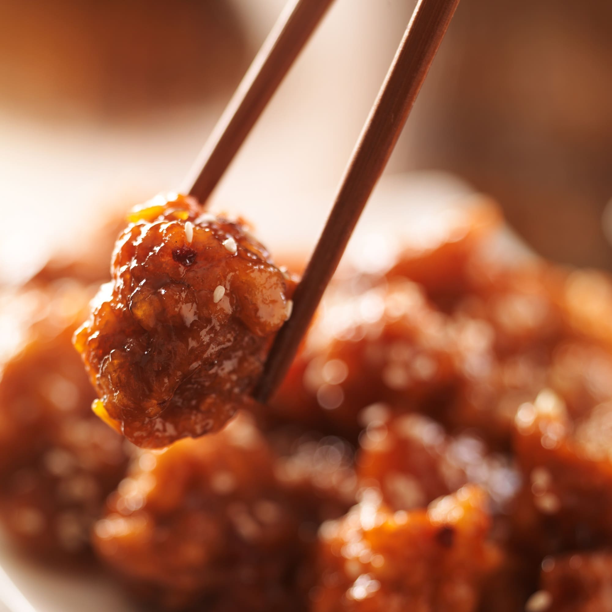 eating chinese chicken with chopsticks