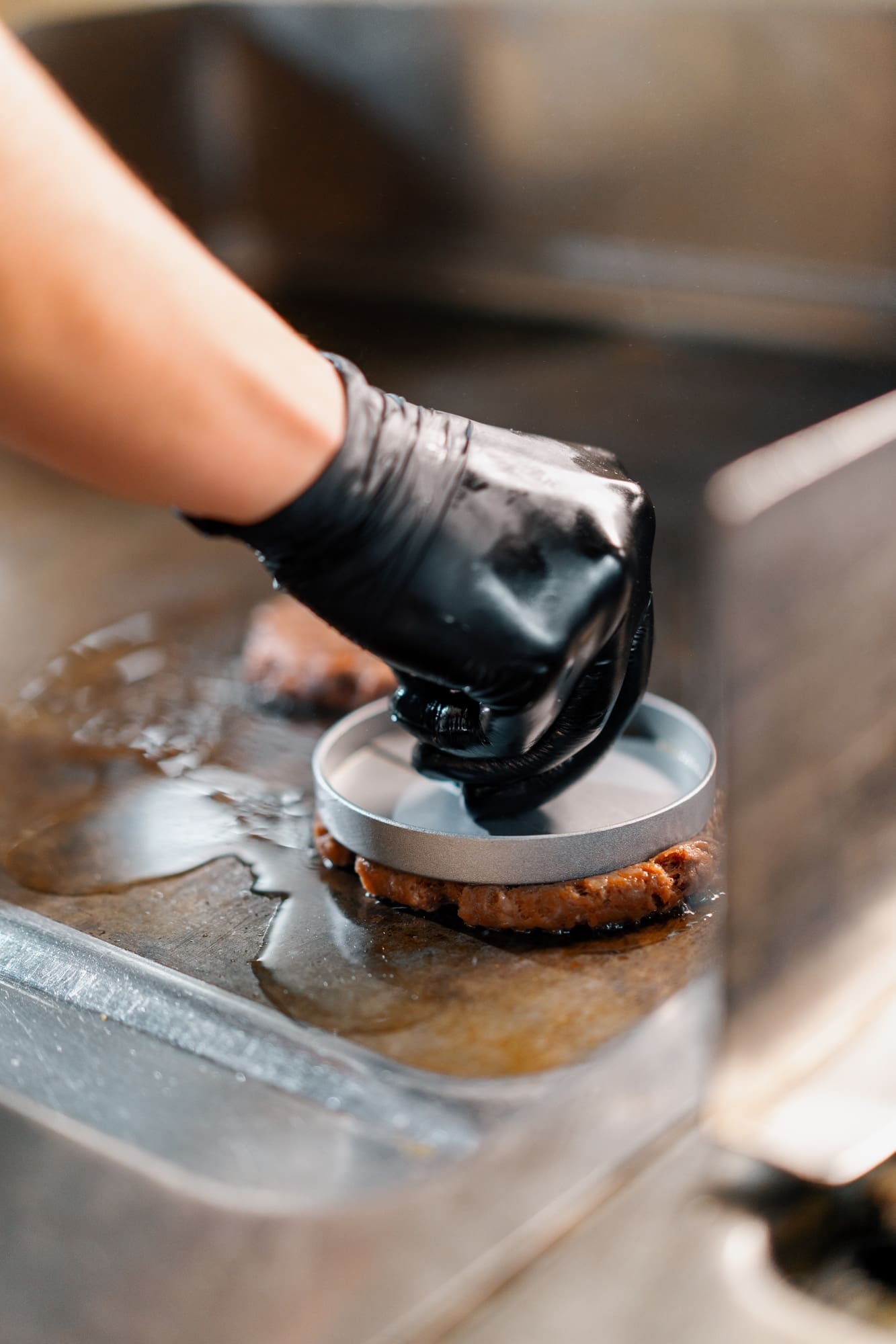 The chef in the kitchen of restaurant makes cutlets for hamburgers smash burger beefsteak