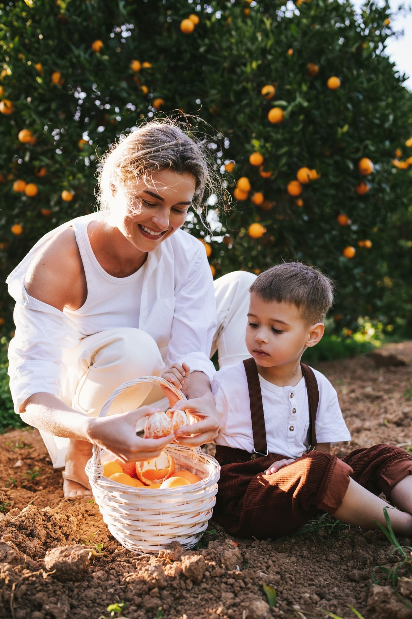 MenuCochon - Gourmet and tasty recipes Young Mother and Son Harvesting Oranges Together