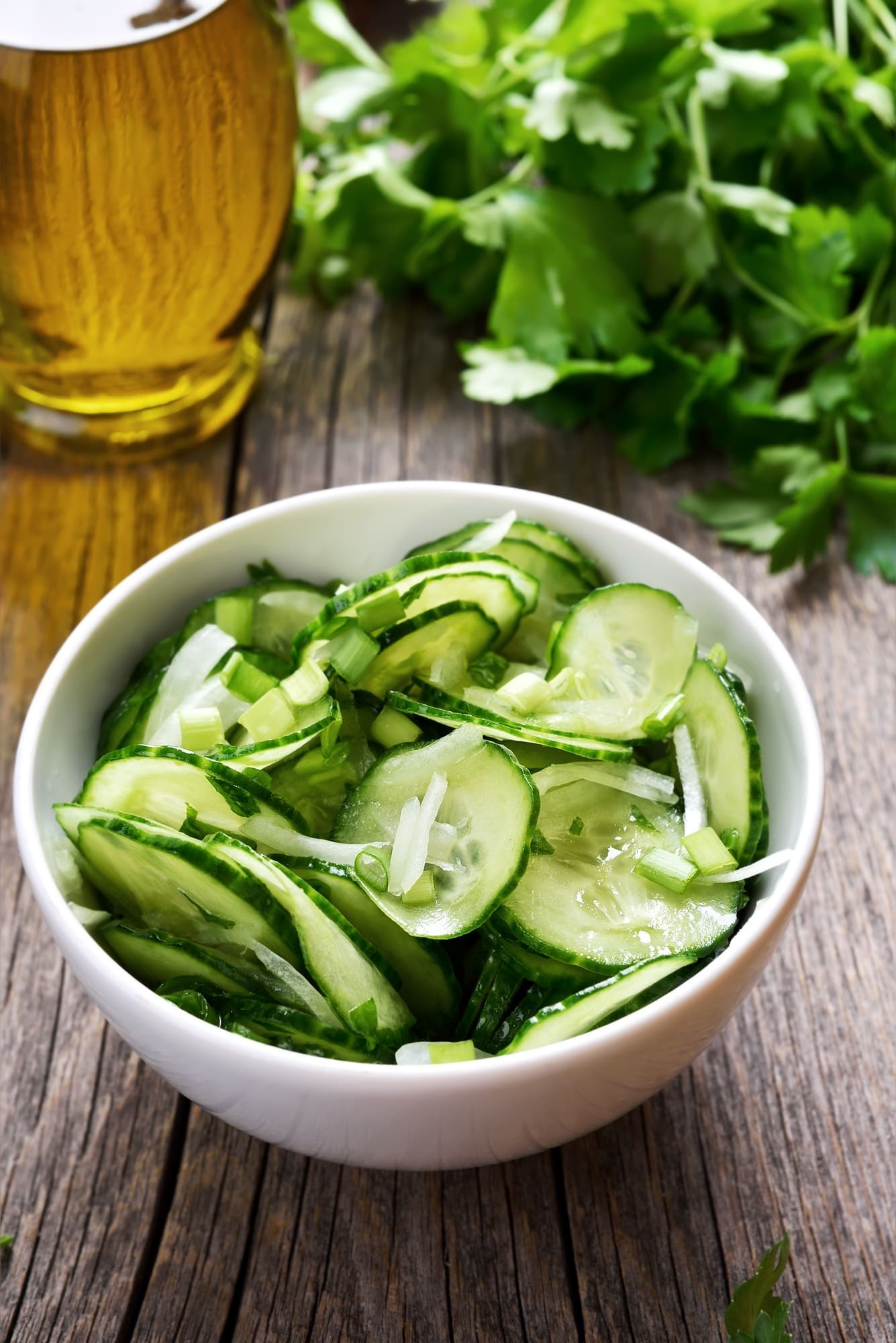 Crisp, fresh cucumber salad served in a wooden bowl